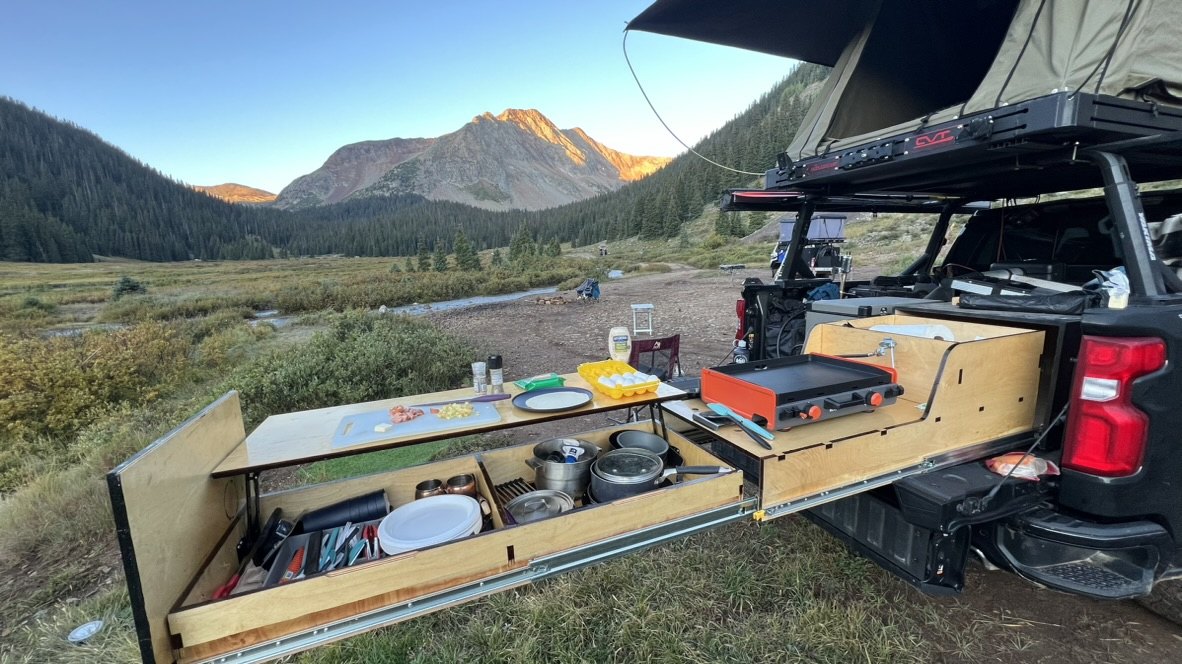 Andrew's overland camp kitchen beside a mountain valley